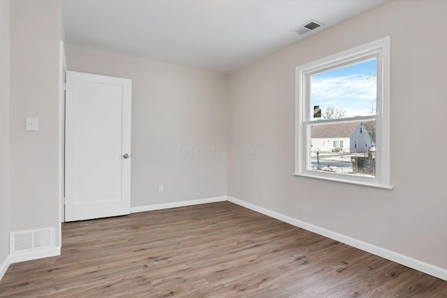 spare room featuring light wood-type flooring