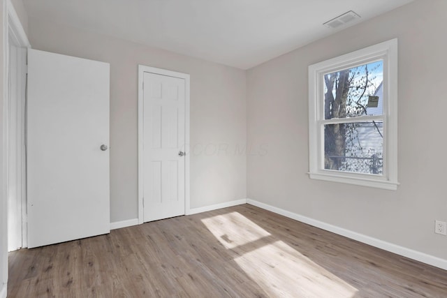 unfurnished bedroom with hardwood / wood-style floors