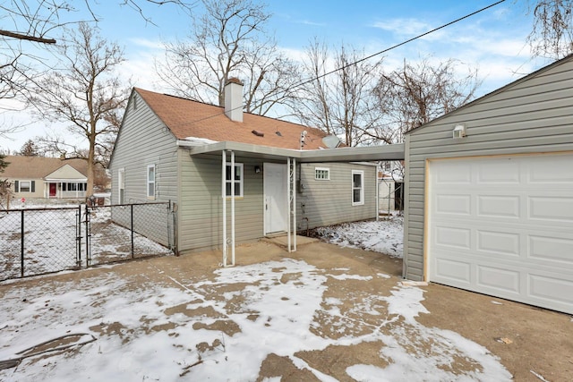 exterior space with a garage and an outdoor structure