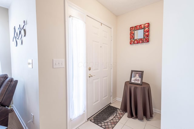 tiled foyer entrance featuring a textured ceiling