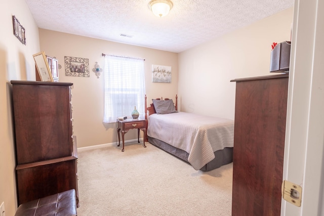 bedroom featuring carpet and a textured ceiling