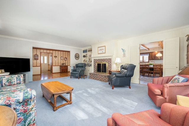 carpeted living room with ornamental molding, a fireplace, and built in features