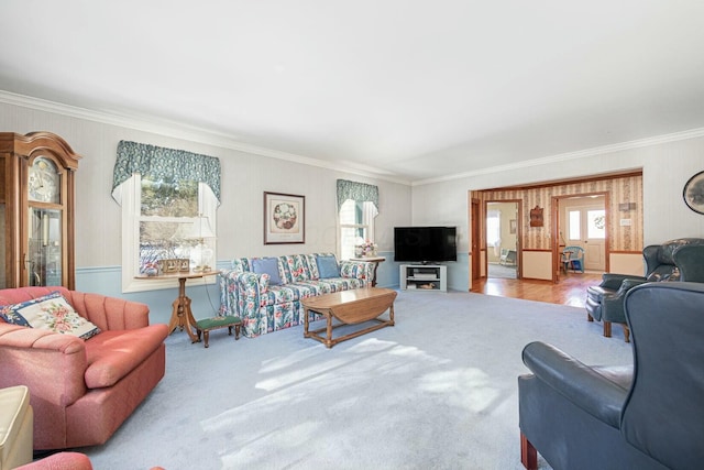 living room with ornamental molding and light colored carpet