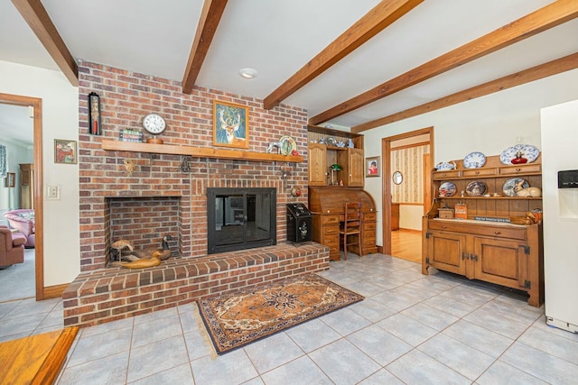 tiled living room with a brick fireplace and beamed ceiling