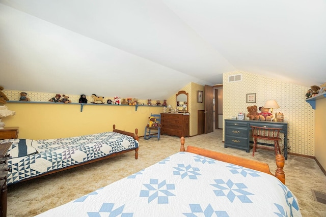 bedroom featuring light colored carpet and lofted ceiling