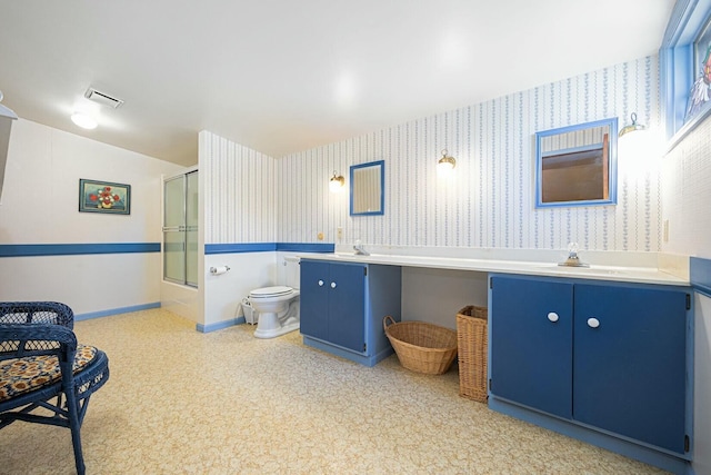 bathroom featuring vanity, toilet, and walk in shower