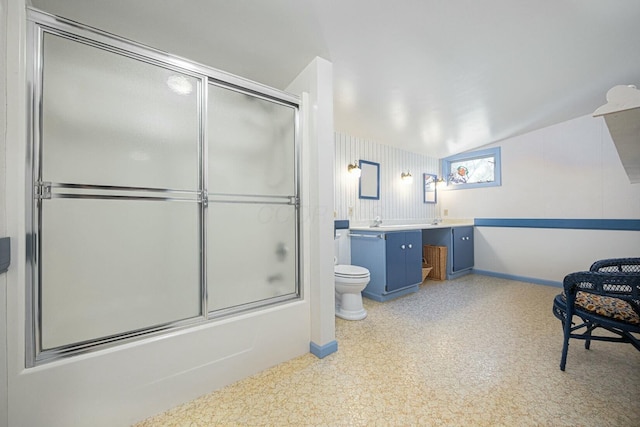 full bathroom featuring vanity, bath / shower combo with glass door, and toilet