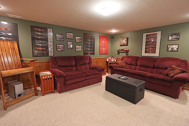 living room with carpet and wooden walls