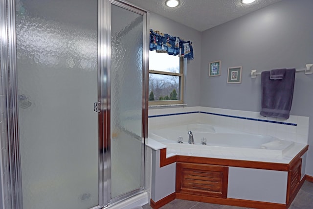 bathroom featuring plus walk in shower and a textured ceiling