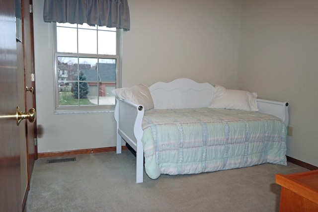 bedroom featuring light carpet