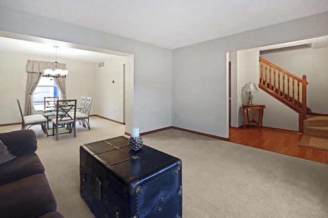 living room featuring an inviting chandelier and carpet