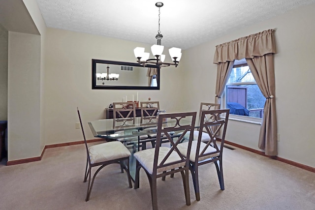 dining area featuring a notable chandelier, light colored carpet, and a textured ceiling