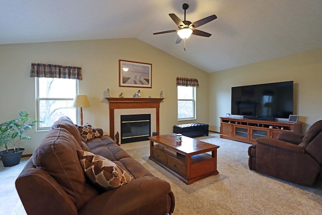 carpeted living room with ceiling fan, vaulted ceiling, and a healthy amount of sunlight