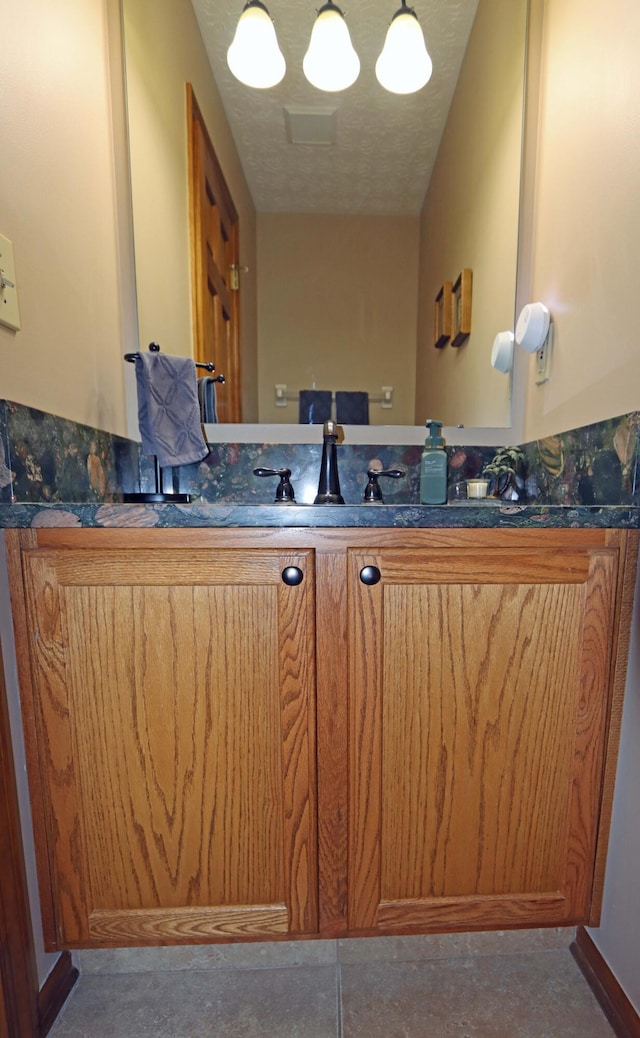 bathroom featuring vanity and a textured ceiling