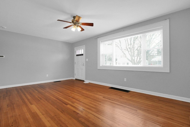 empty room featuring hardwood / wood-style flooring and ceiling fan