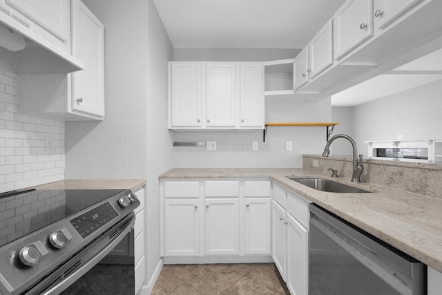 kitchen with light tile patterned flooring, sink, appliances with stainless steel finishes, white cabinets, and backsplash