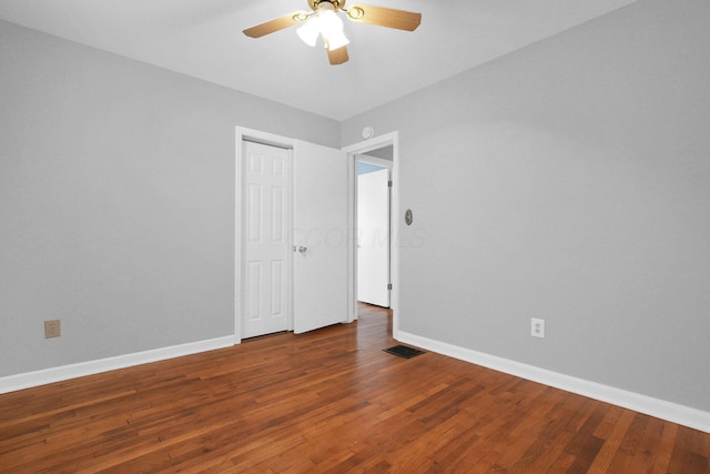 spare room with hardwood / wood-style floors and ceiling fan