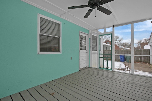 unfurnished sunroom featuring ceiling fan