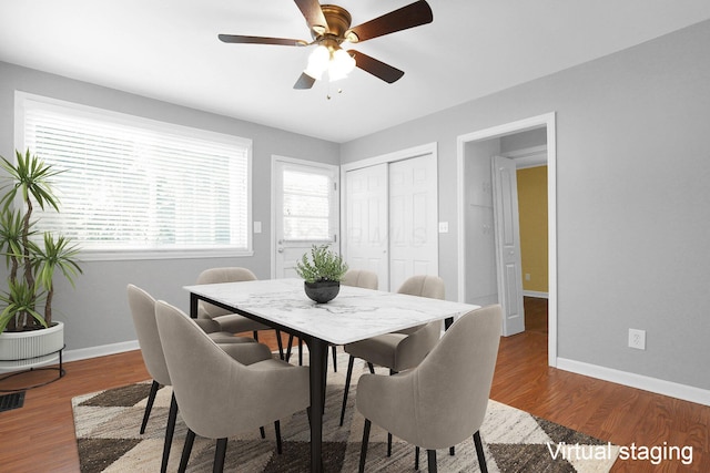 dining area with hardwood / wood-style floors and ceiling fan