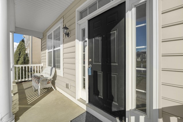 entrance to property featuring covered porch