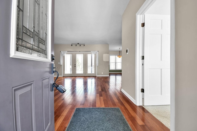 foyer entrance with french doors and dark hardwood / wood-style floors