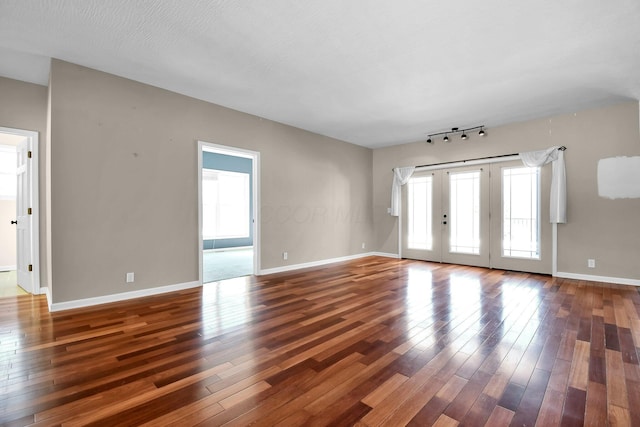 unfurnished room with dark hardwood / wood-style flooring