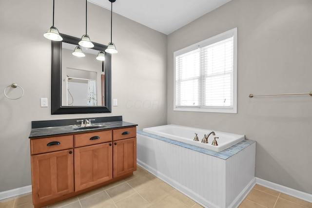 bathroom featuring vanity, tile patterned flooring, and a bathtub