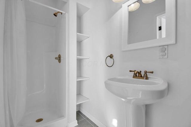 bathroom with sink, tile patterned floors, and walk in shower