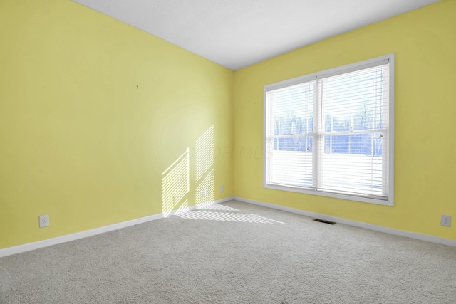 spare room featuring light colored carpet