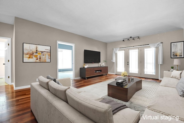 living room featuring a wealth of natural light and dark hardwood / wood-style flooring