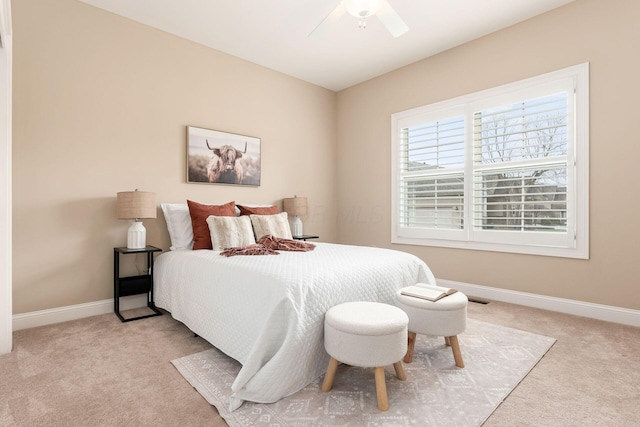 bedroom featuring light colored carpet and ceiling fan