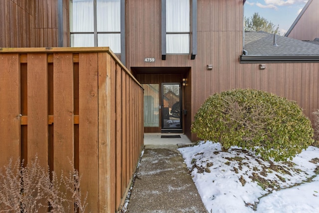 view of snow covered property entrance