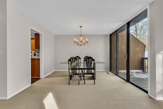 carpeted dining room featuring a textured ceiling and a notable chandelier