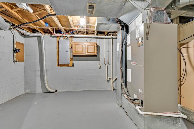 basement featuring heating unit and electric panel