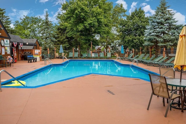 view of swimming pool with a patio