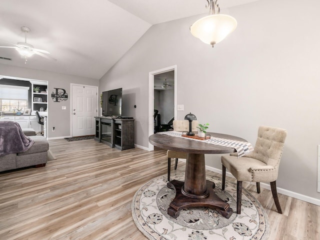 interior space with ceiling fan, vaulted ceiling, and light wood-type flooring