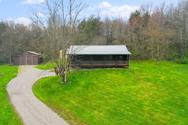 view of front of house with an outbuilding and a front yard