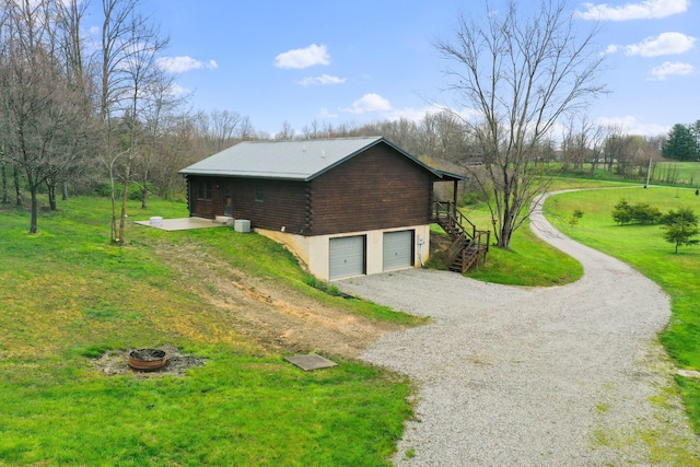 view of property exterior featuring a garage and a yard