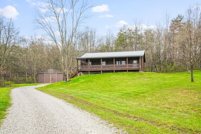 view of front of property with a garage, an outdoor structure, and a front yard