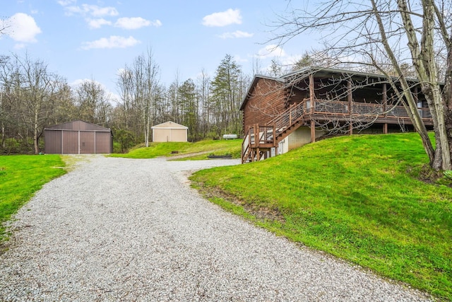 exterior space featuring an outdoor structure, a yard, and a deck