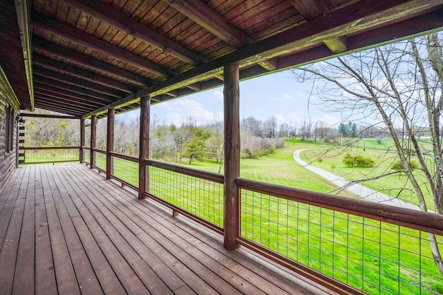 wooden deck featuring a lawn