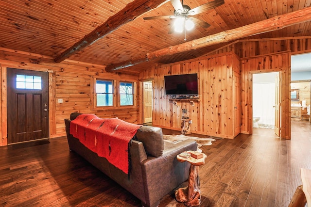 living room with wood-type flooring, a wealth of natural light, and wooden walls