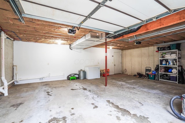 garage featuring a garage door opener and fridge