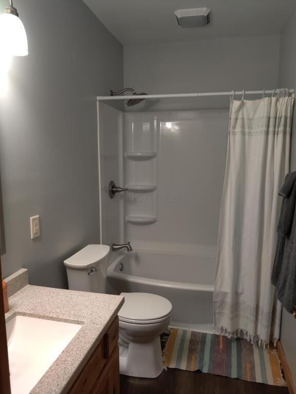 full bathroom featuring vanity, toilet, and shower / bath combo with shower curtain