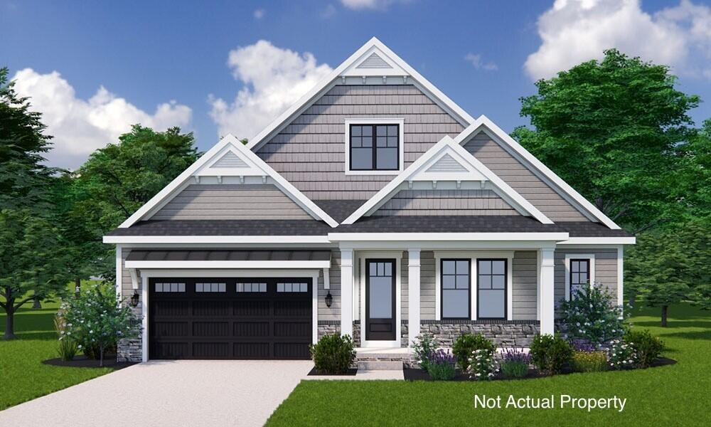 view of front of house featuring a garage and a front lawn