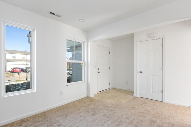 spare room with light colored carpet