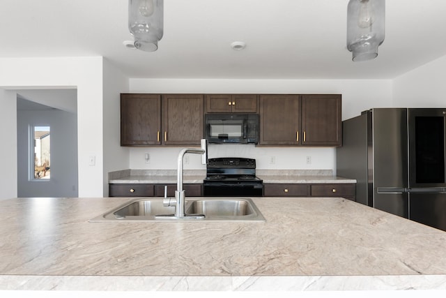 kitchen featuring sink, dark brown cabinetry, and black appliances