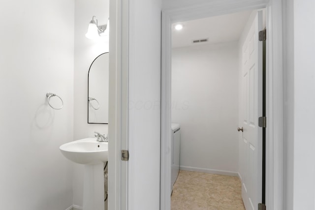 bathroom with sink and washer and dryer