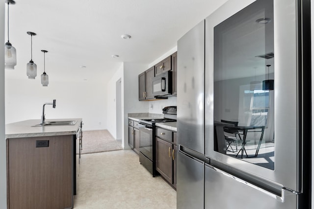 kitchen with dark brown cabinetry, sink, decorative light fixtures, and black appliances