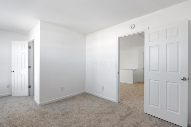 unfurnished room with light carpet